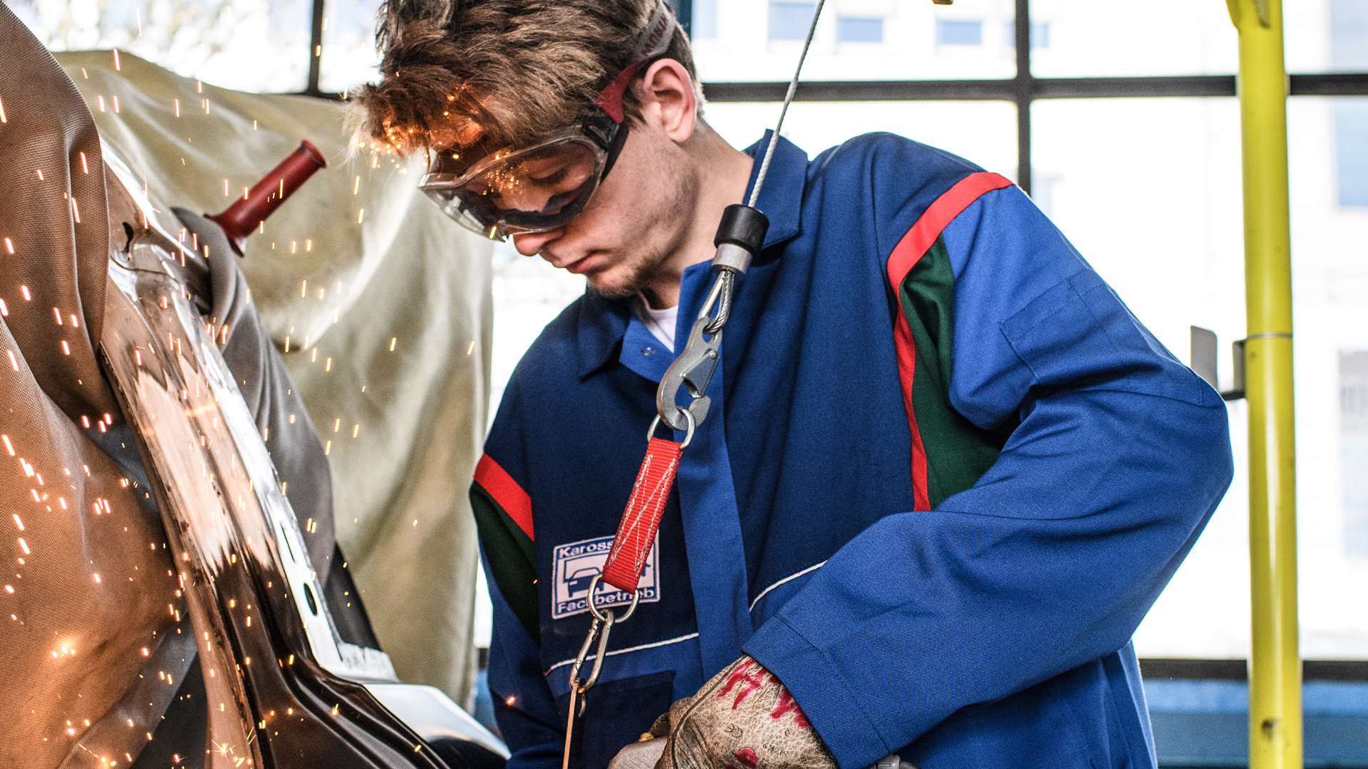 Young man working on a car body